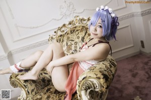 A woman with blue hair and a flower crown on her head.