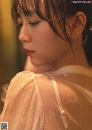 A magazine spread with a woman in a white dress.