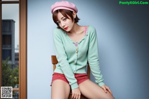 A woman in a pink jacket and yellow shorts posing for a picture.
