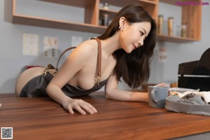 A woman sitting at a bar with a cup of coffee.