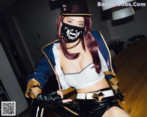 A woman in a black and gold outfit crouching on a table.