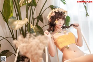 A woman in a yellow top and white thong.