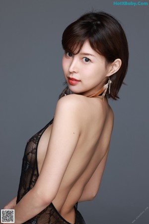 A woman wearing a black bra and a black veil.
