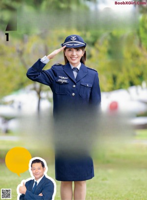 A woman in a military uniform laying on the grass.