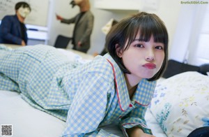 A woman laying on top of a bed in an office.
