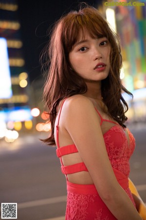 A woman in a white bra and panties posing for a picture.