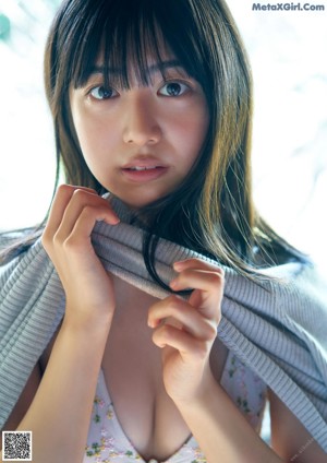 A woman sitting on top of a bed in a white underwear.